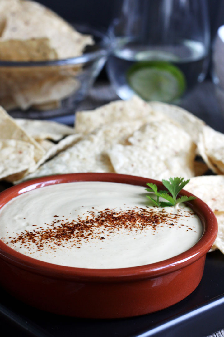 Vegan queso dip with tortilla chips.