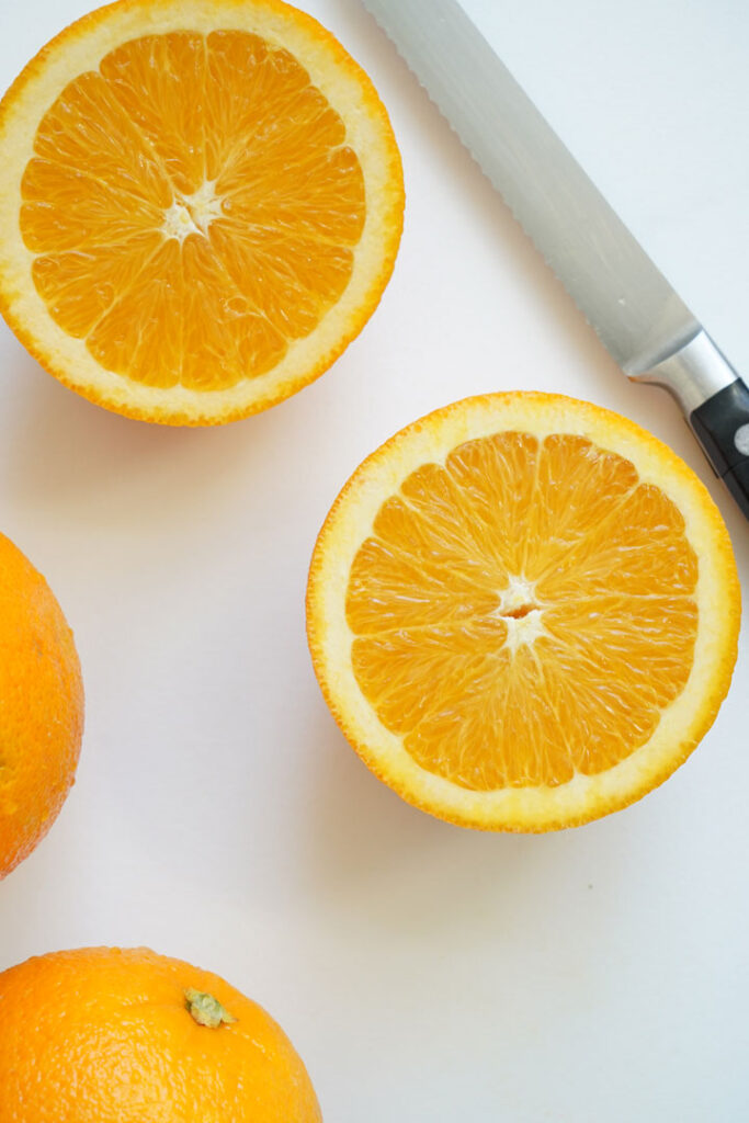 Sliced orange halves on a cutting board.