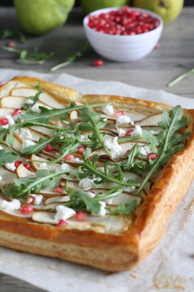 Close up view of the top of a baked pear and goat cheese tart.