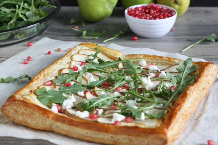 Baked puff pastry tart on parchment paper.