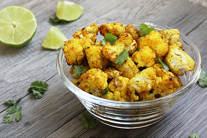 Roasted cauliflower in a clear bowl.