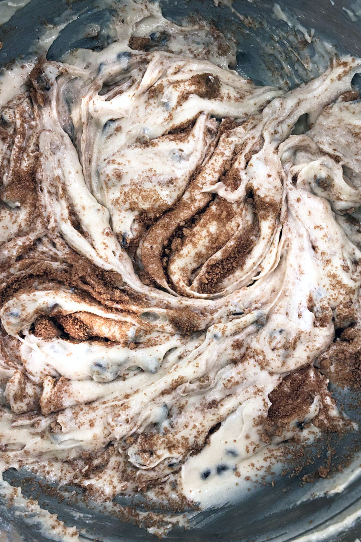 Muffin batter showing swirls of cinnamon filling.