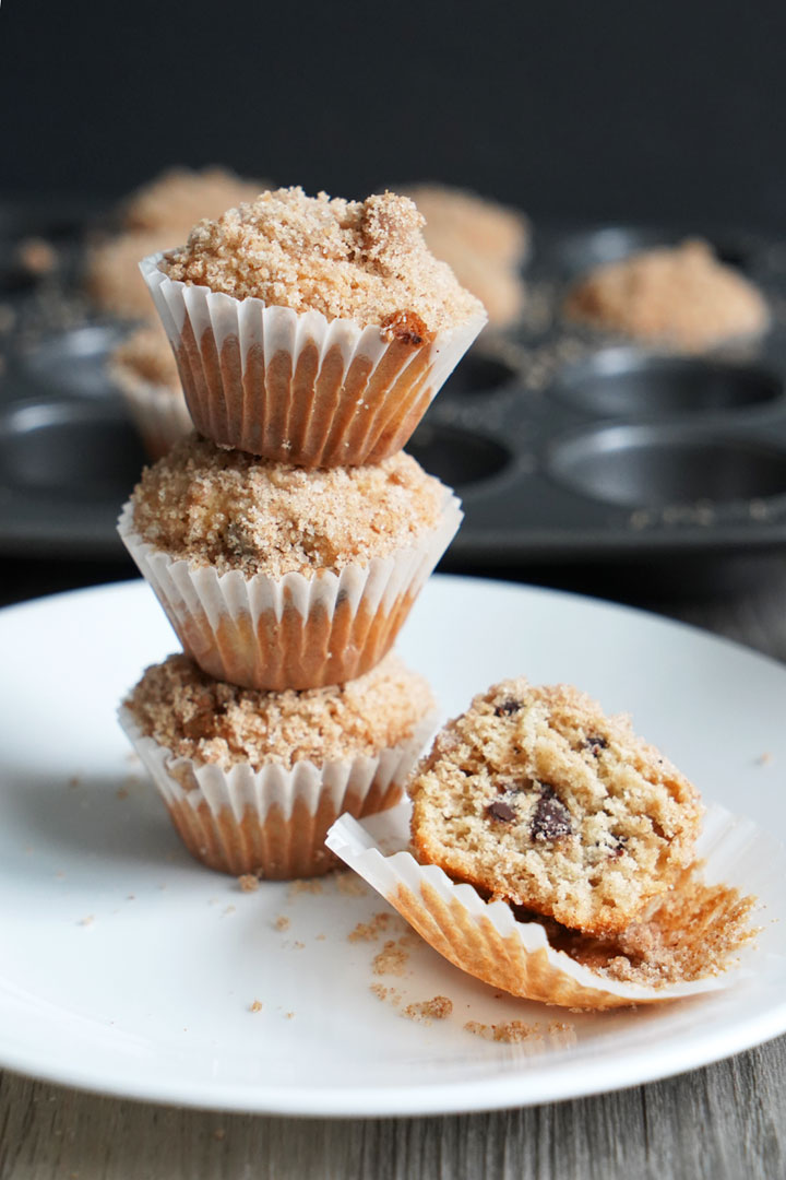 Three mini coffee cake muffins stack on top of each other. 