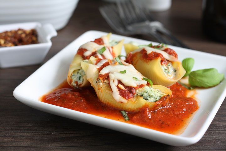 3 stuffed shells on a white plate.