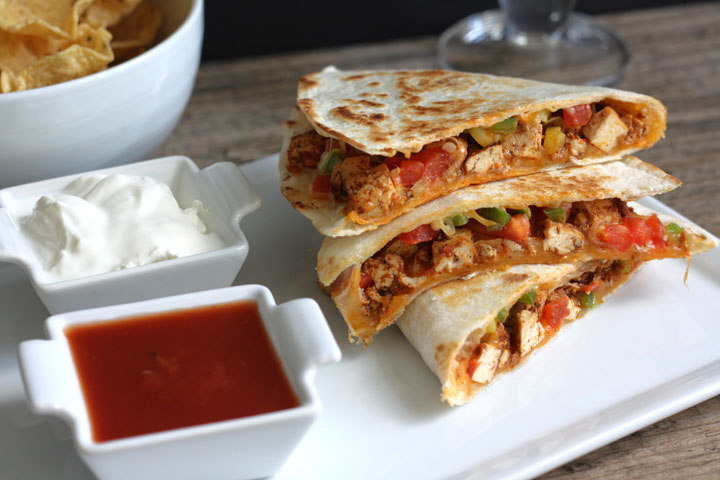 Tofu quesadillas served with salsa and sour cream.