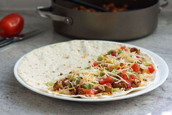 Uncooked quesadilla showing filling in the tortilla.