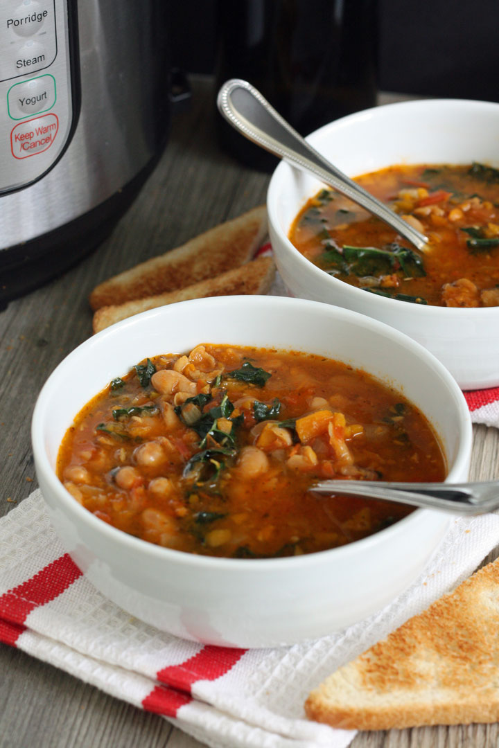 Tomato and Cannellini Bean soup in a white bowls next to Instant Pot.