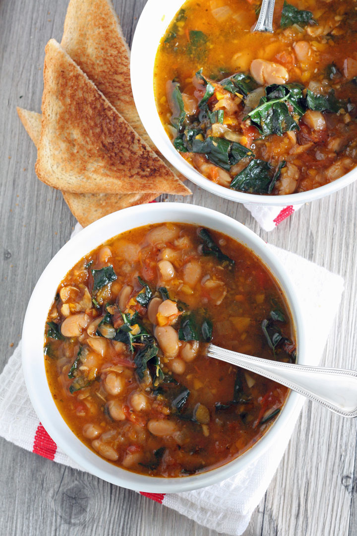 Overhead view of soup bowls with toast on the side.