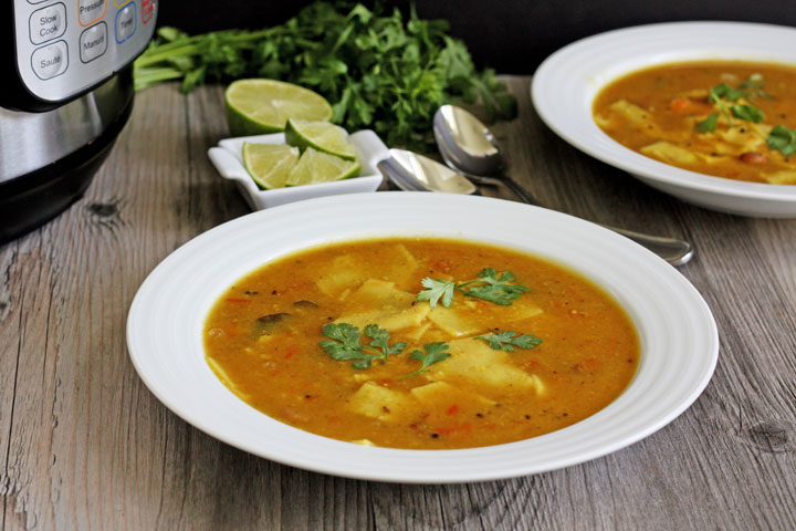 Dal dhokli in a white plate with Instant Pot to the side.