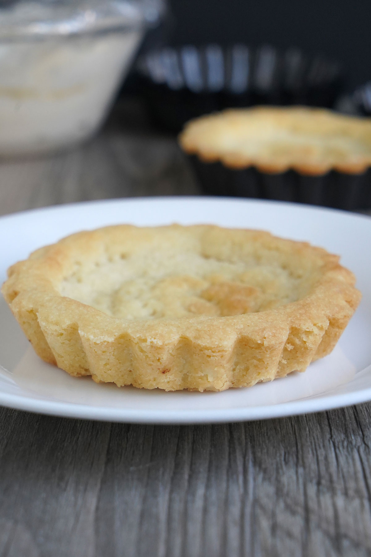 An unfilled small shortbread tart crust.