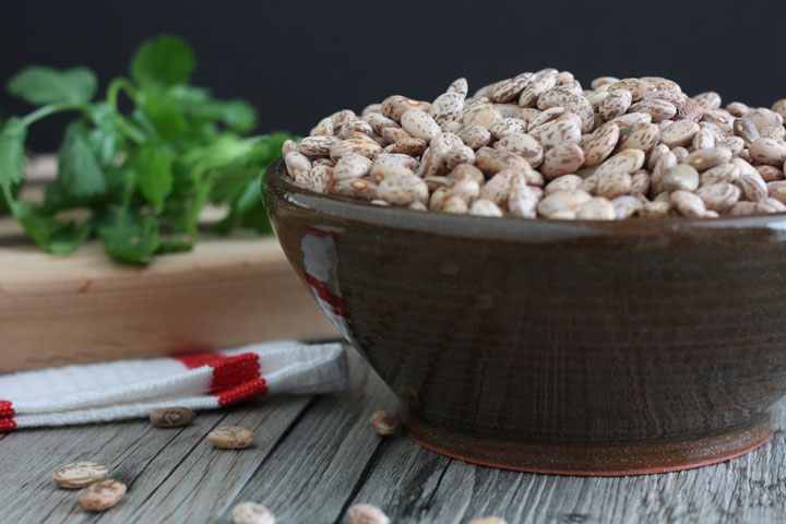 Dry pinto beans in a bowl.