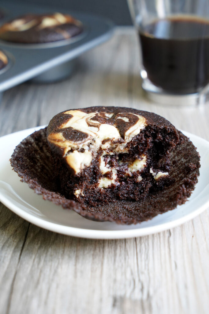 Inside of a black bottom cupcake shown on white plate.