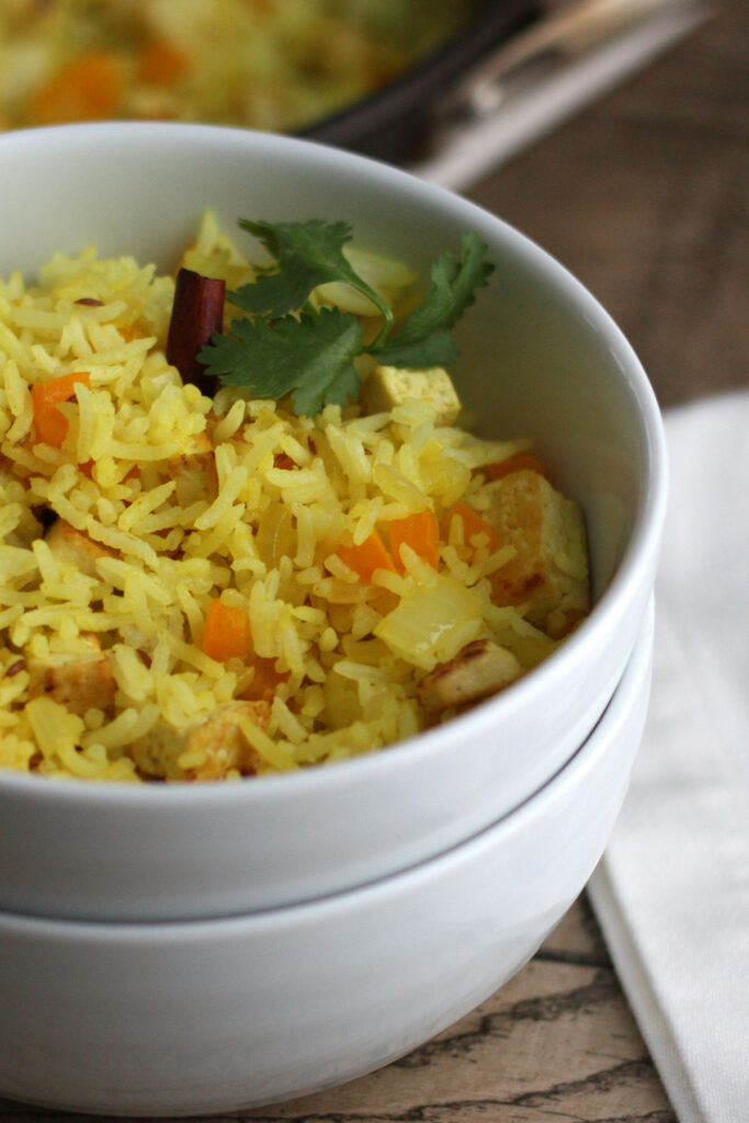 Indian fried rice in a white bowl.