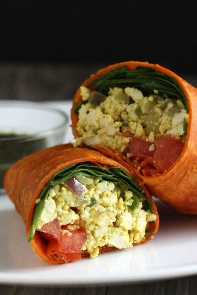 Tofu Scramble inside wrap with spinach and tomato.