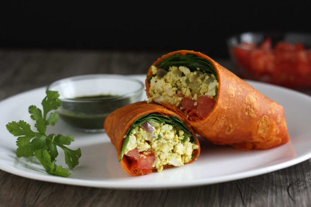 Tofu scramble wraps on white plate with chutney.