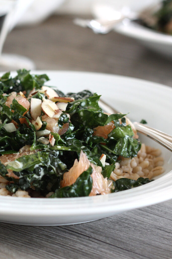 Close up view of Kale and Barley salad sprinkled with sliced almonds