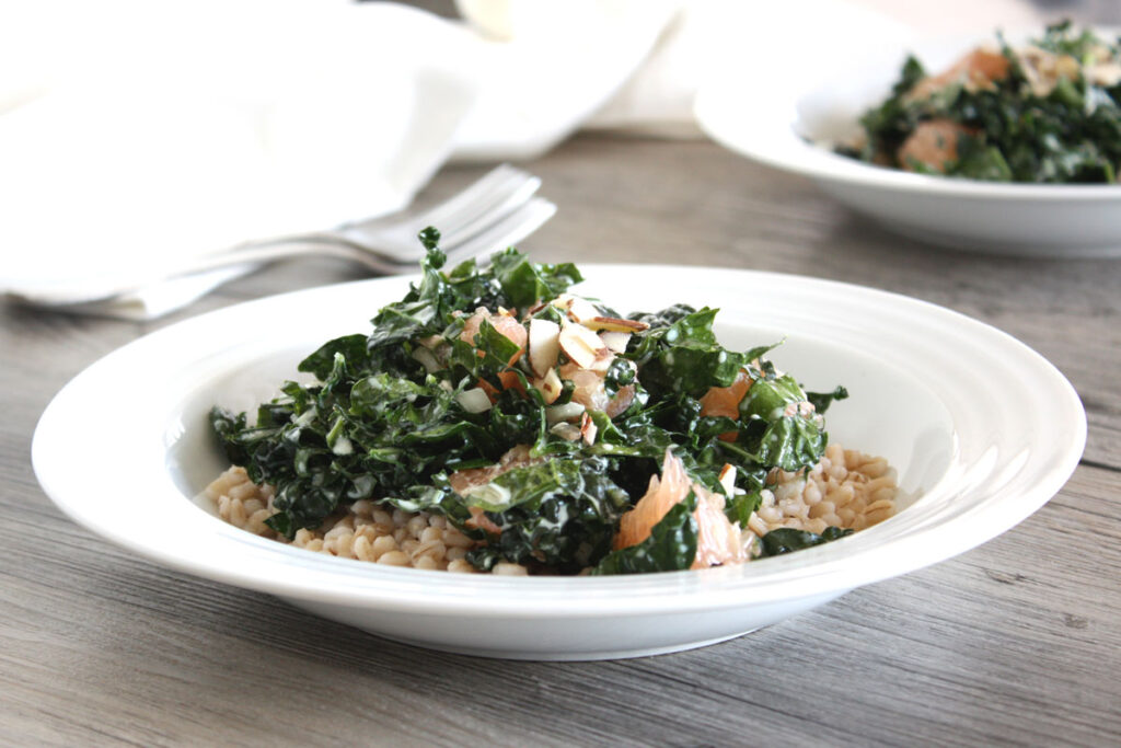 Kale and barley salad in a white plate. 