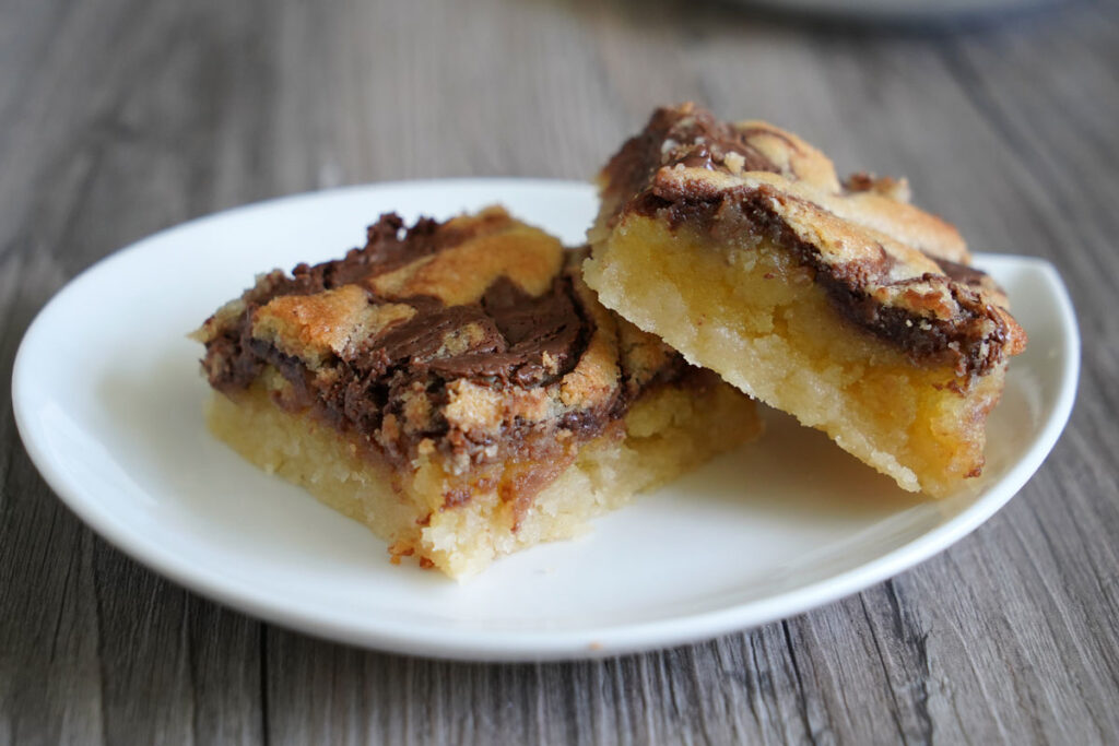 Landscape orientation view of two Nutella bars on a white plate. 