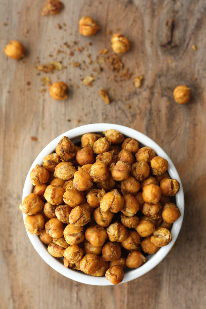 BIrd's eye view of roasted chickpeas in a white bowl.