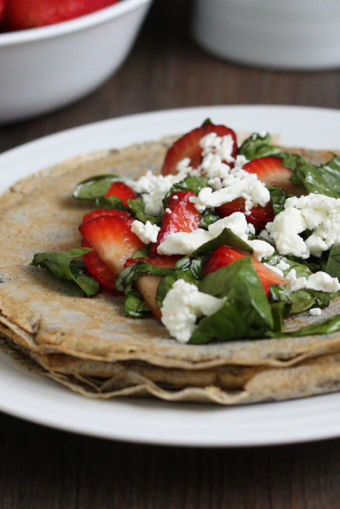 Strawberry, spinach, goat cheese and basil filling on top of  buckwheat crepe.