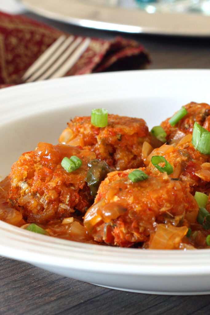 Close up of baked cabbage Manchurian balls in white plate. 