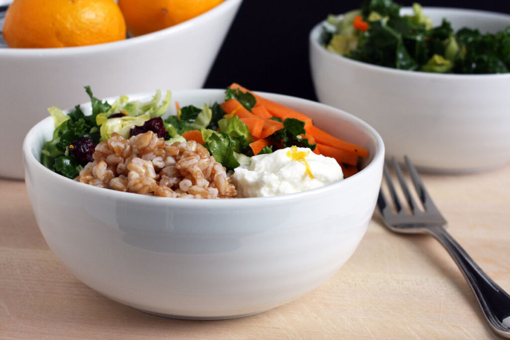 Grain bowl made with farro, shaved brussel sprouts, kale, carrots and yogurt.