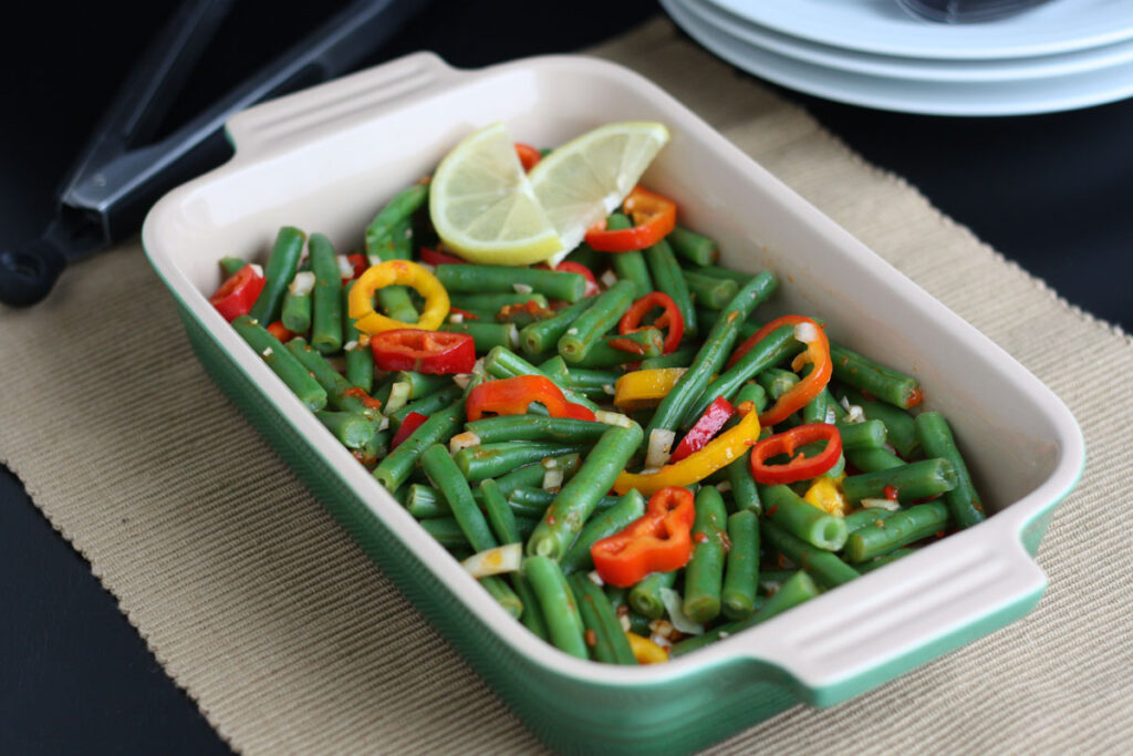 Green Bean Salad with plates on the side.