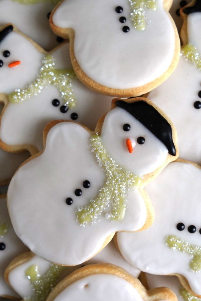 Close up of decorated snowman cookies.