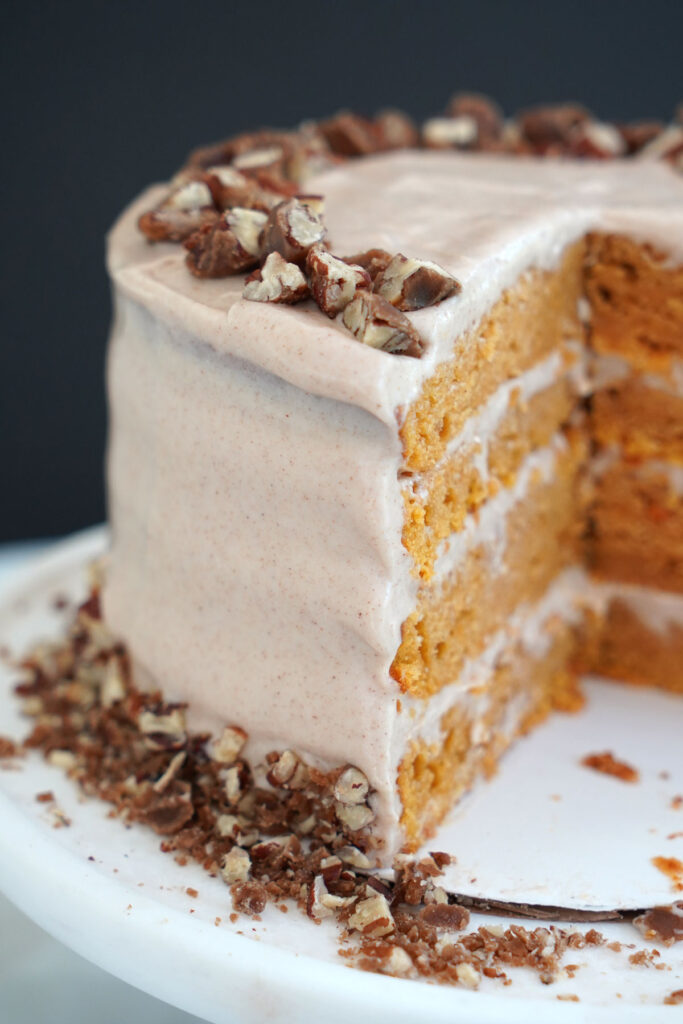 Sweet potato cake with slice vut out showing the four layered cake.