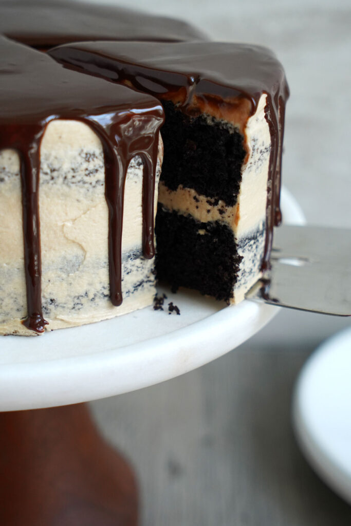 Slice of cake being cut out of the chocolate cake.