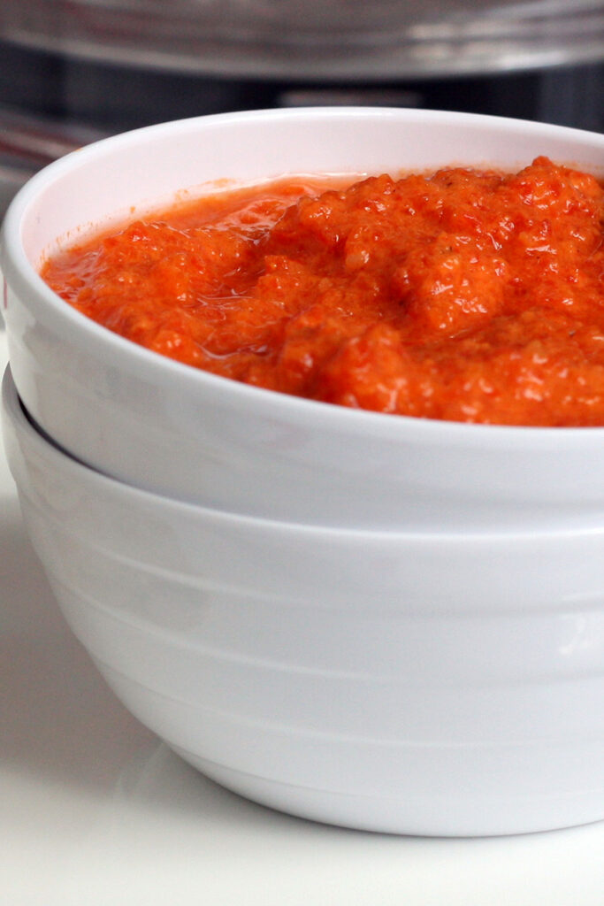 Roasted red pepper dip in a white bowl.