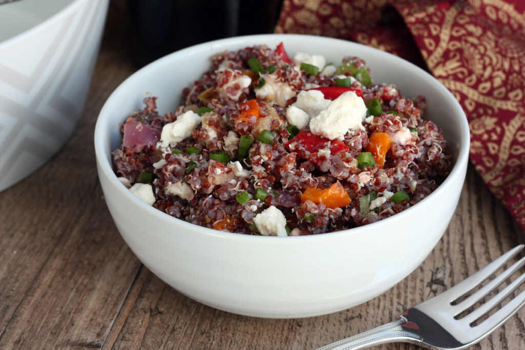 Quinoa salad in a white bowl.