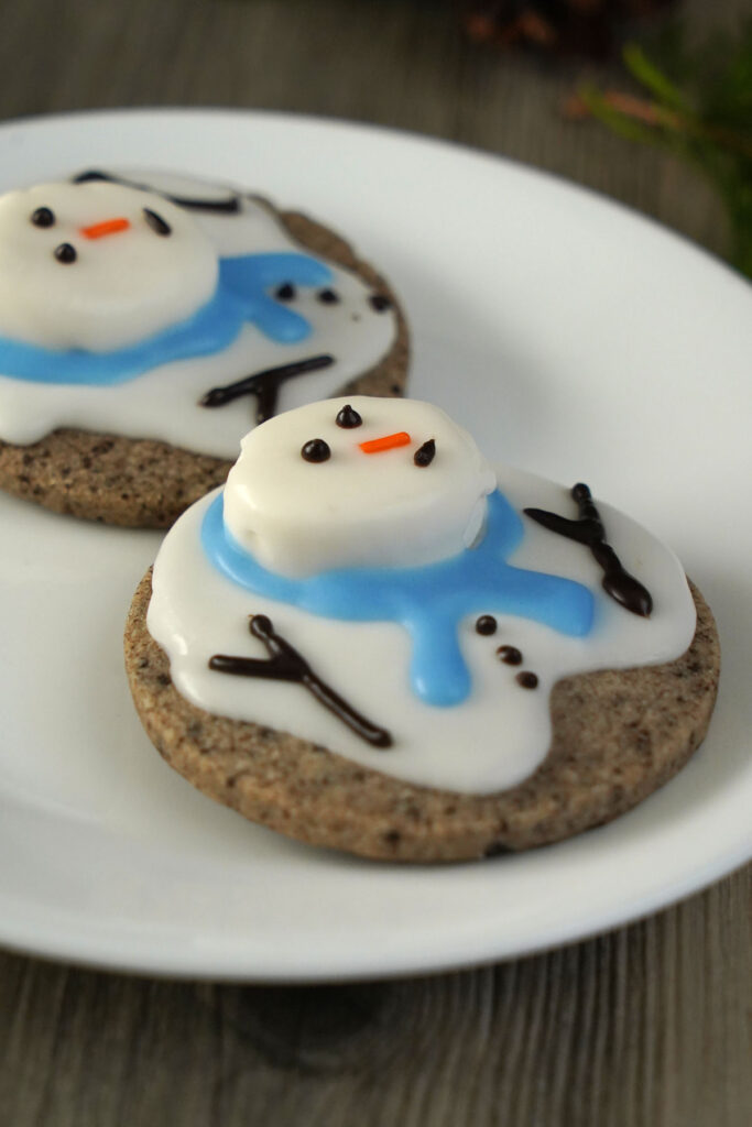 Melted snowman cookies made with cookies and cream dough on a white plate.