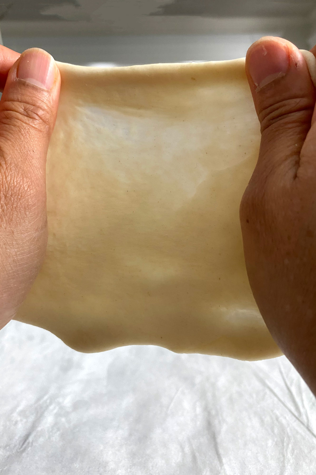 Dough being stretched to demonstrate gluten networks.