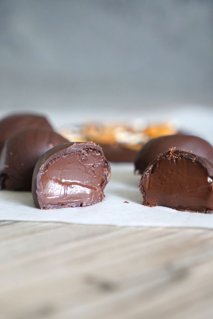 Chocolate coated truffle split in half.