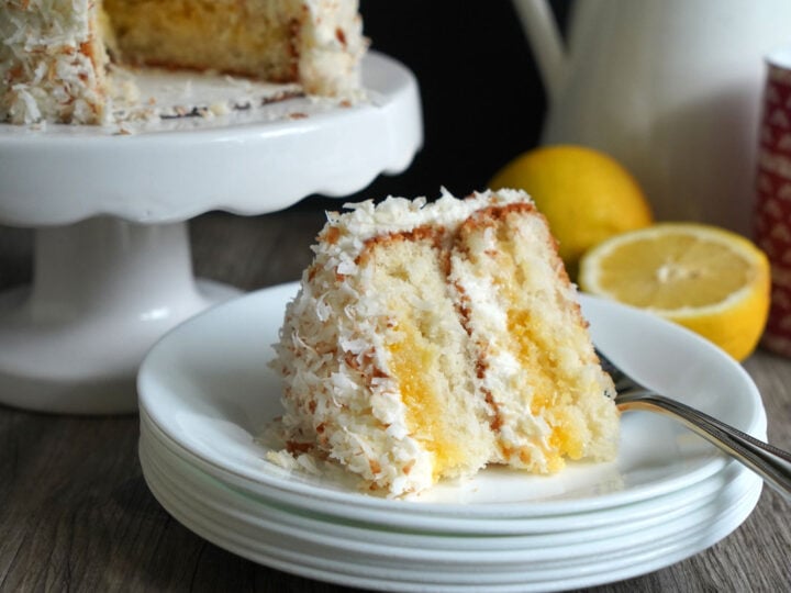 Slice of lemon coconut cake on white plate.