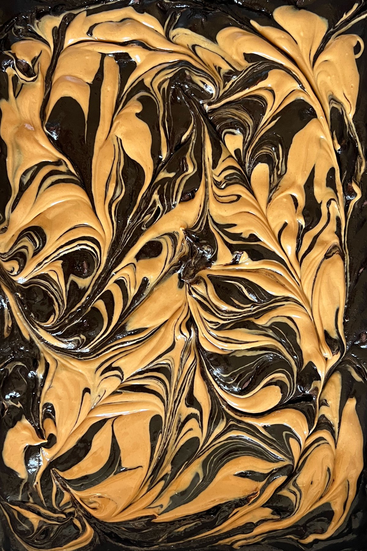 Peanut butter swirls in brownie batter.