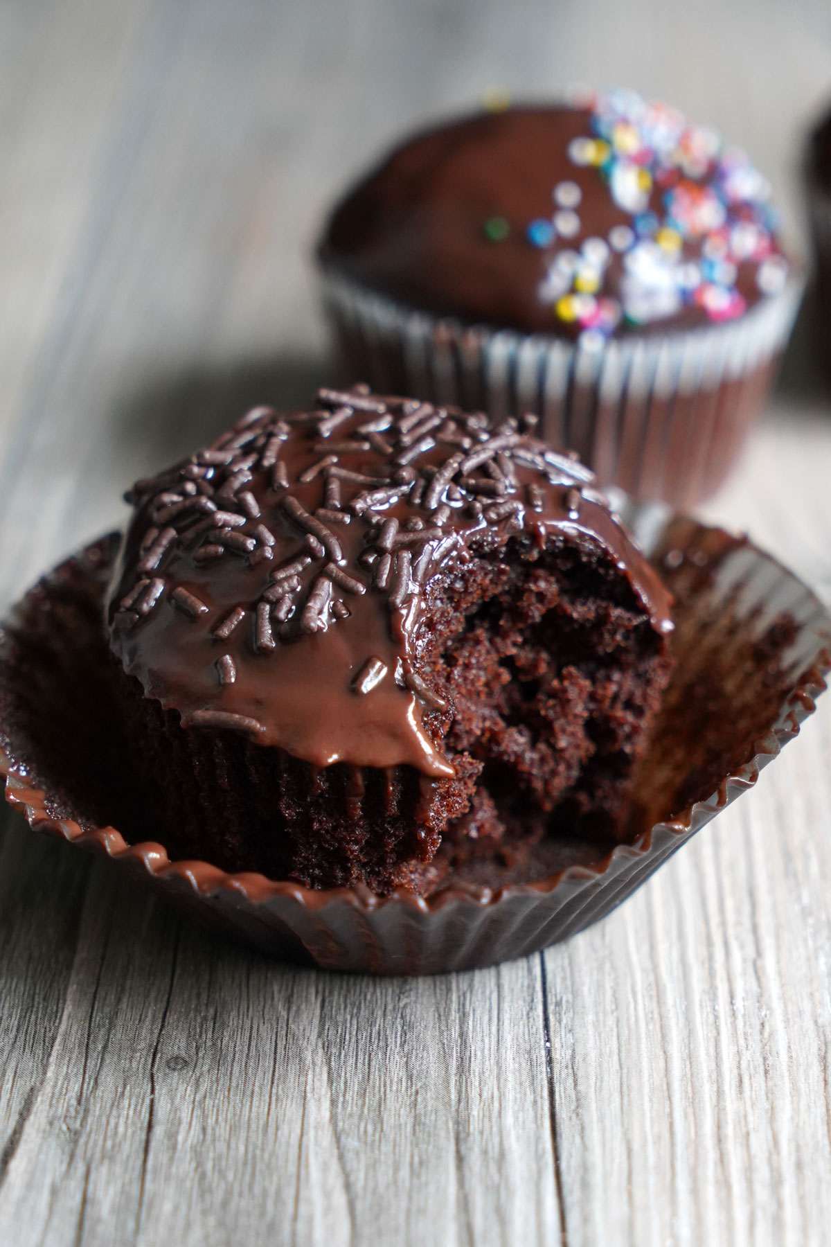 Cupcake with bite taken out to show the inside.