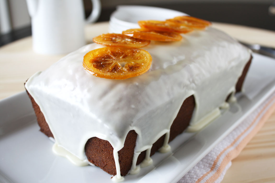 Lemon Pound Cake with Vanilla Glaze and garnished with candied lemon slices on top.