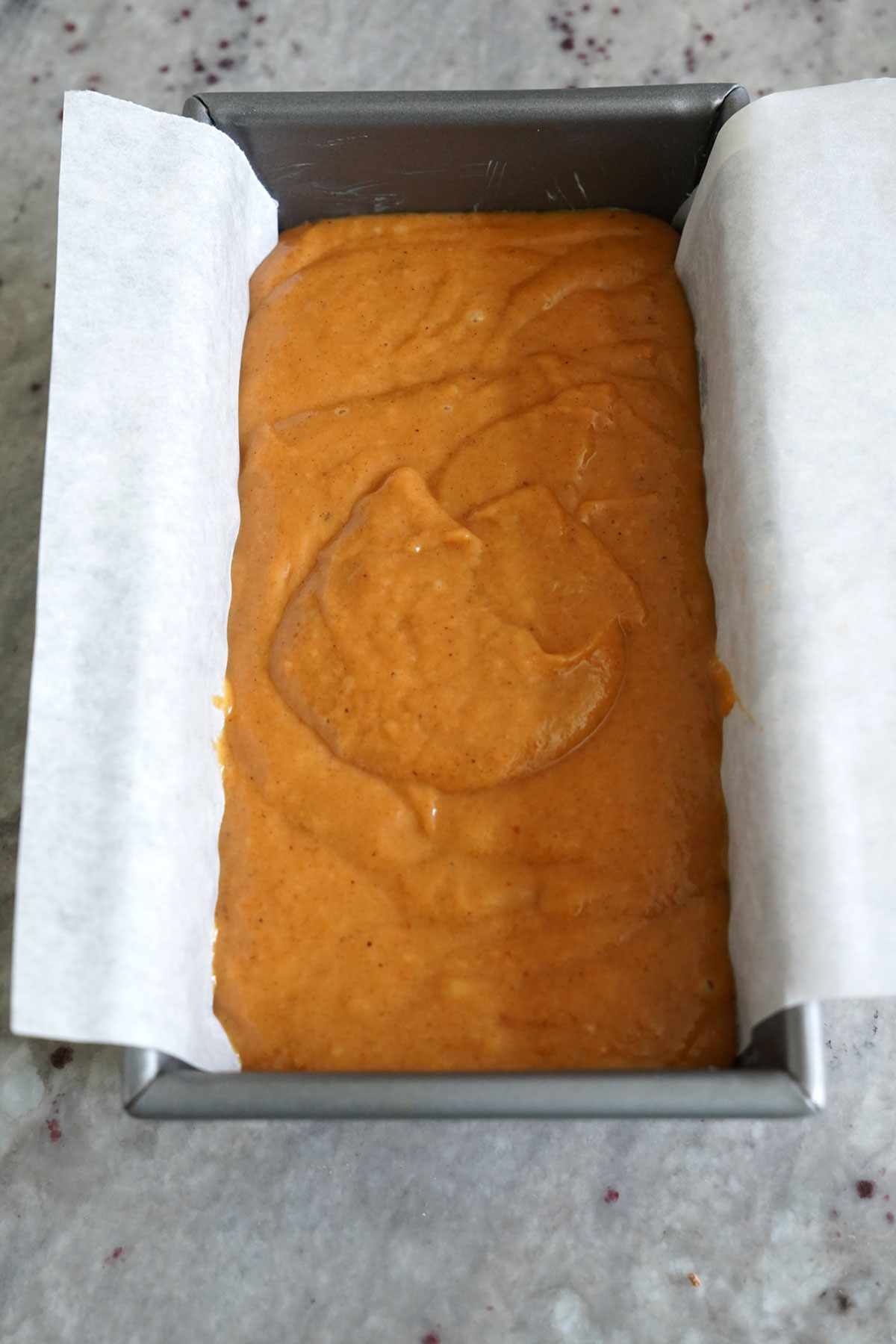 Pumpkin bread batter in loaf pan.