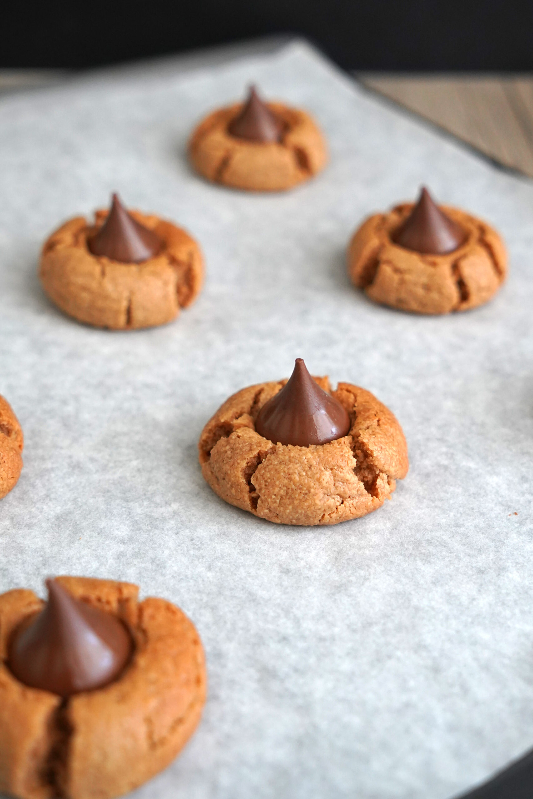 Peanut butter blossom cookies cooling on baking sheet.