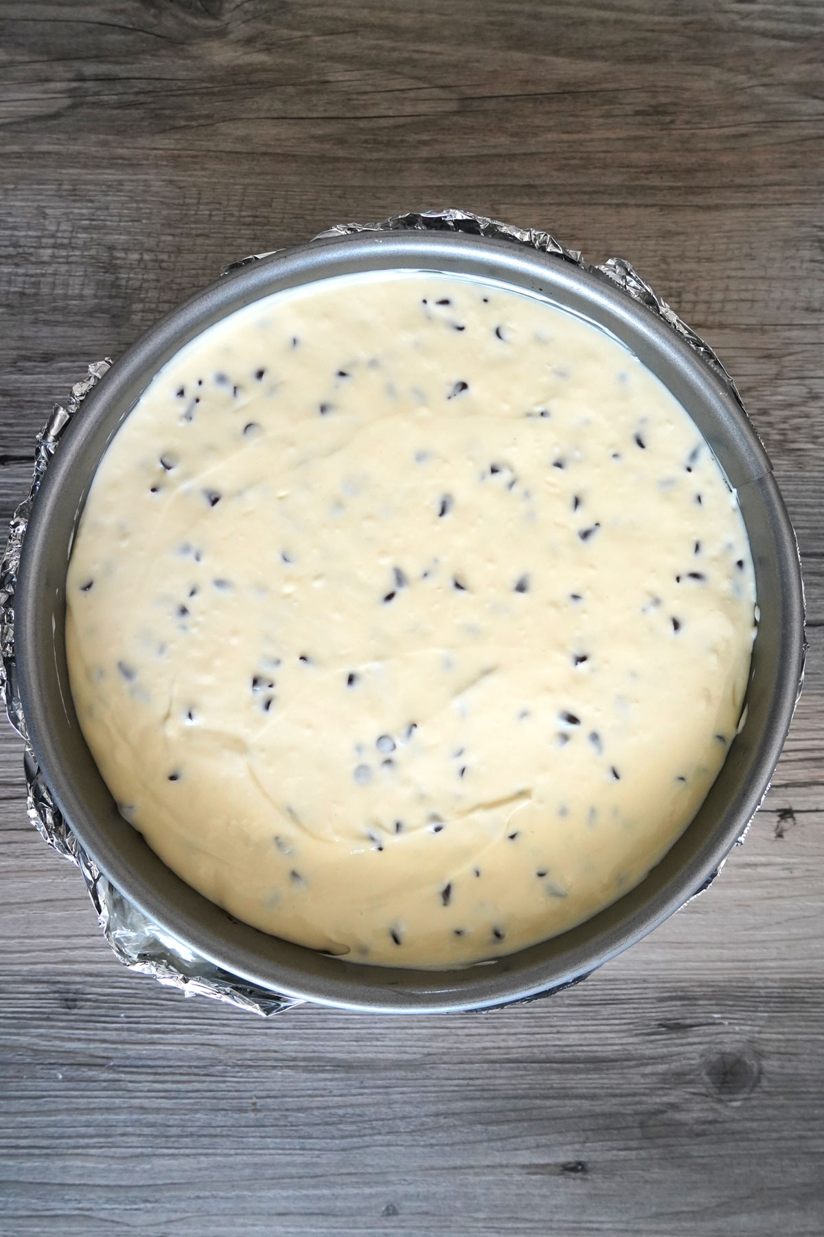 Cheesecake batter in a prepared springform pan.