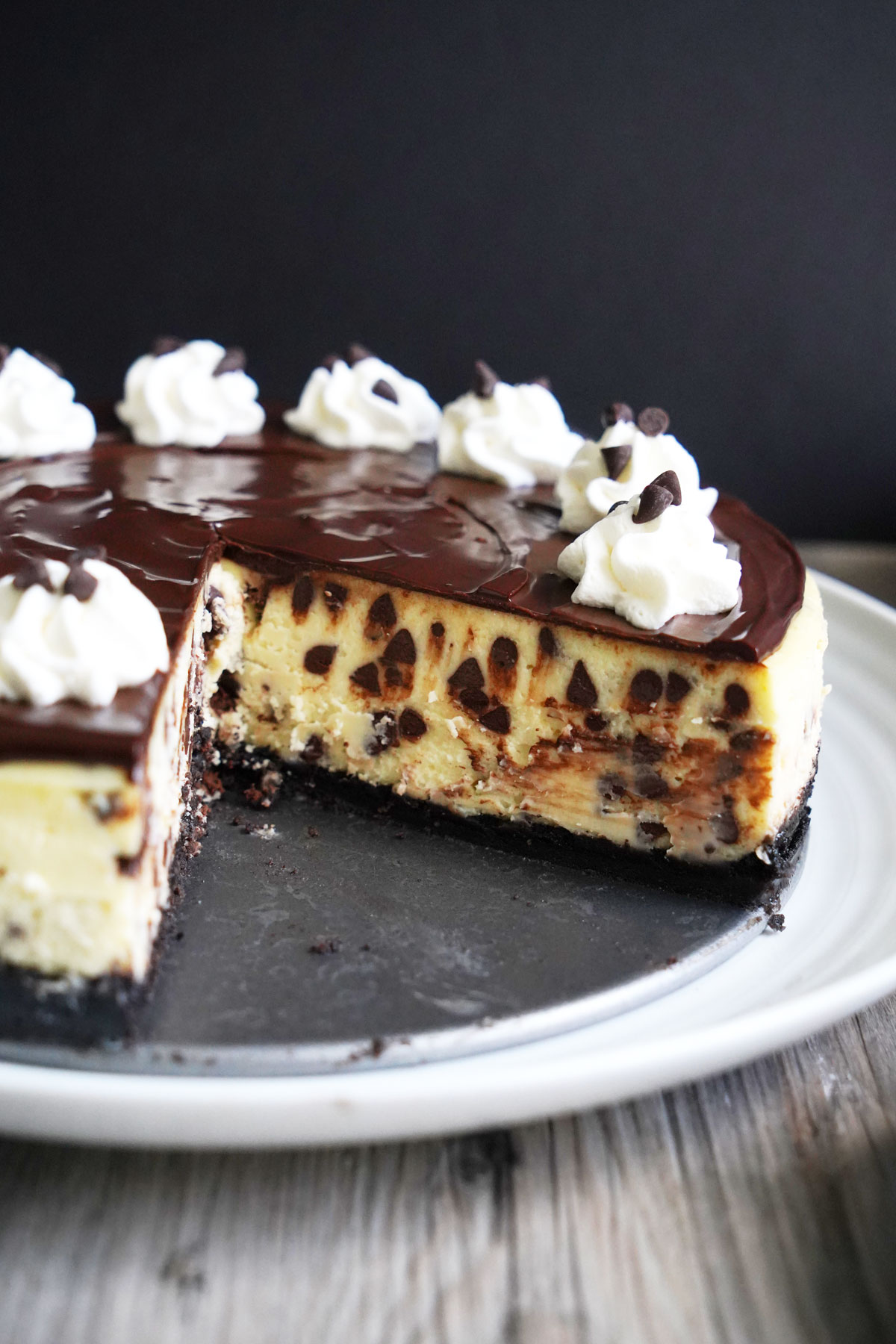 Cheesecake with slices cut out, revealing the inside chocolate chips.