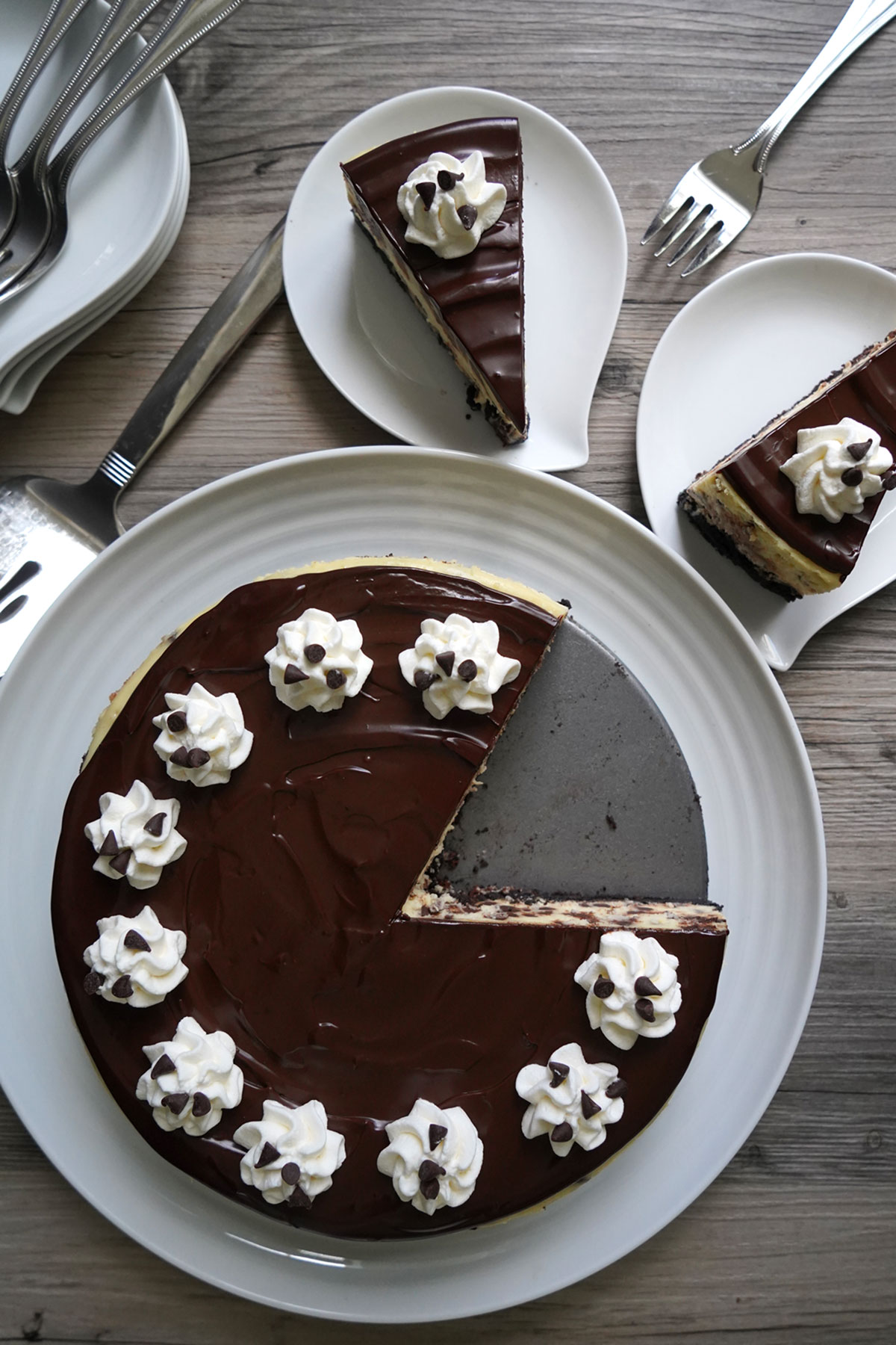 Top view of cut cheesecake with slices plated on the side.