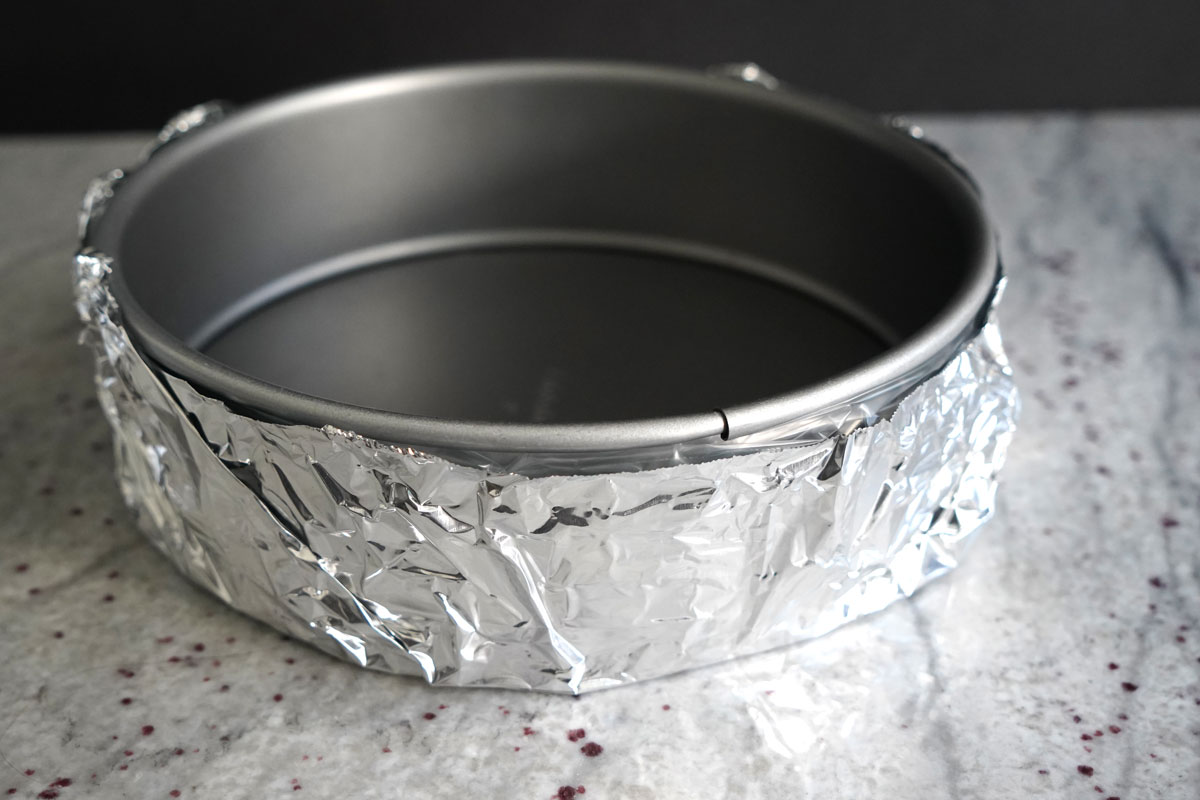 Springform pan wrapped in heavy duty aluminum foil.