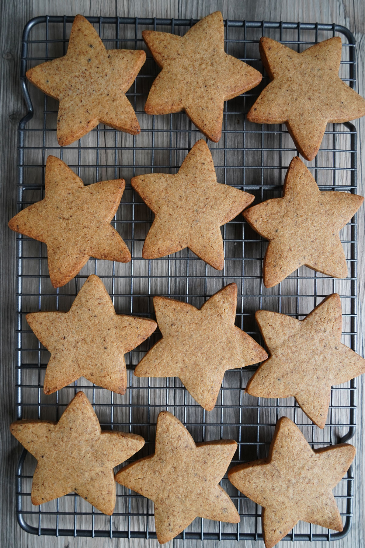 Star shaped sugar cookies on a cooling rack. 