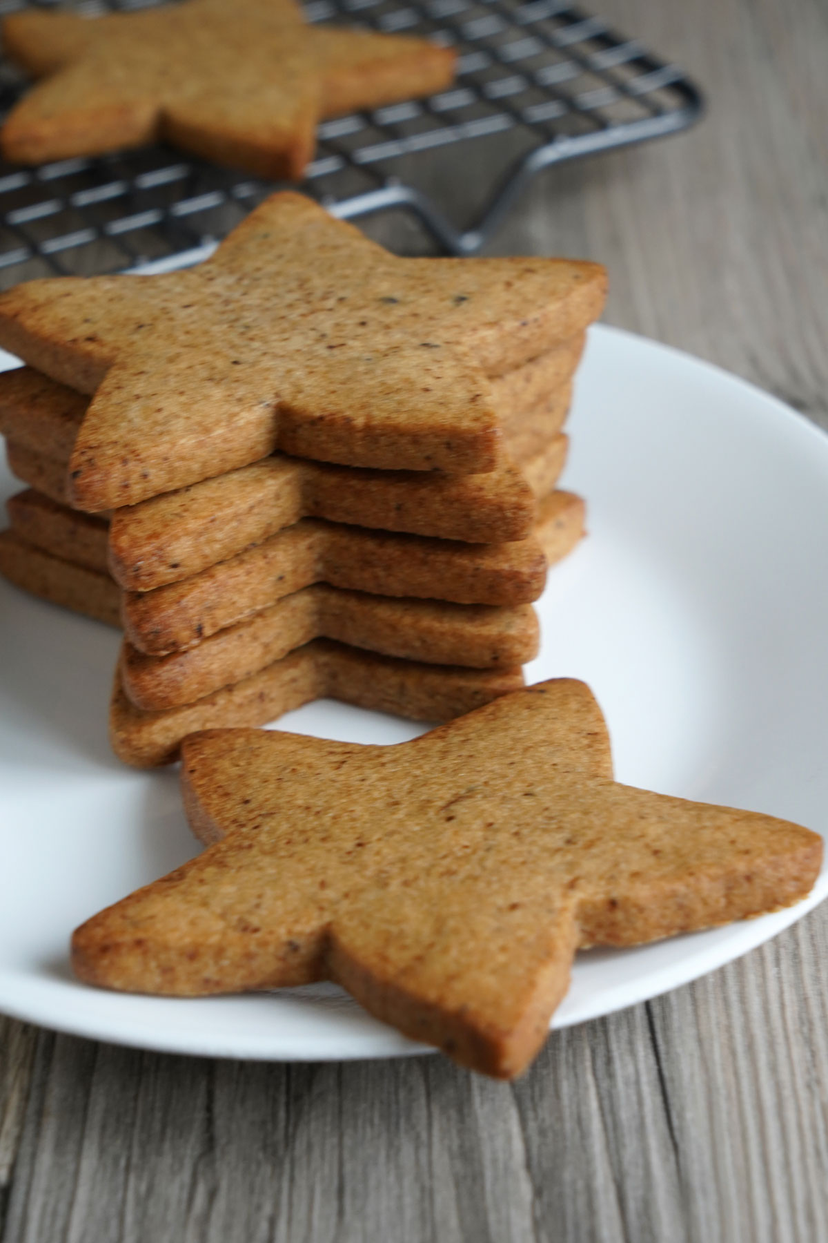 Start shaped espresso sugar cookies stacked on a white plate.