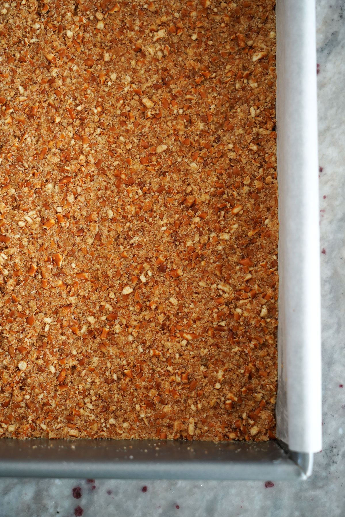 Pretzel crust in baking pan.