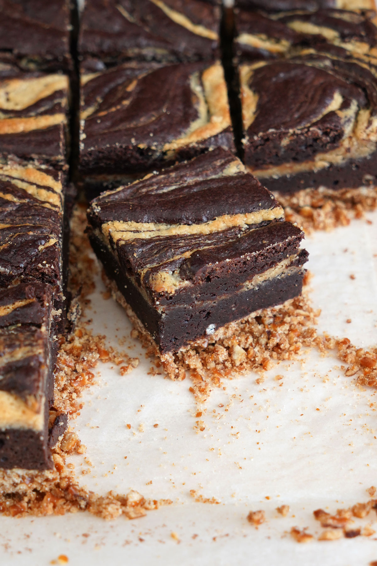 Peanut butter cheesecake brownie on parchment paper.