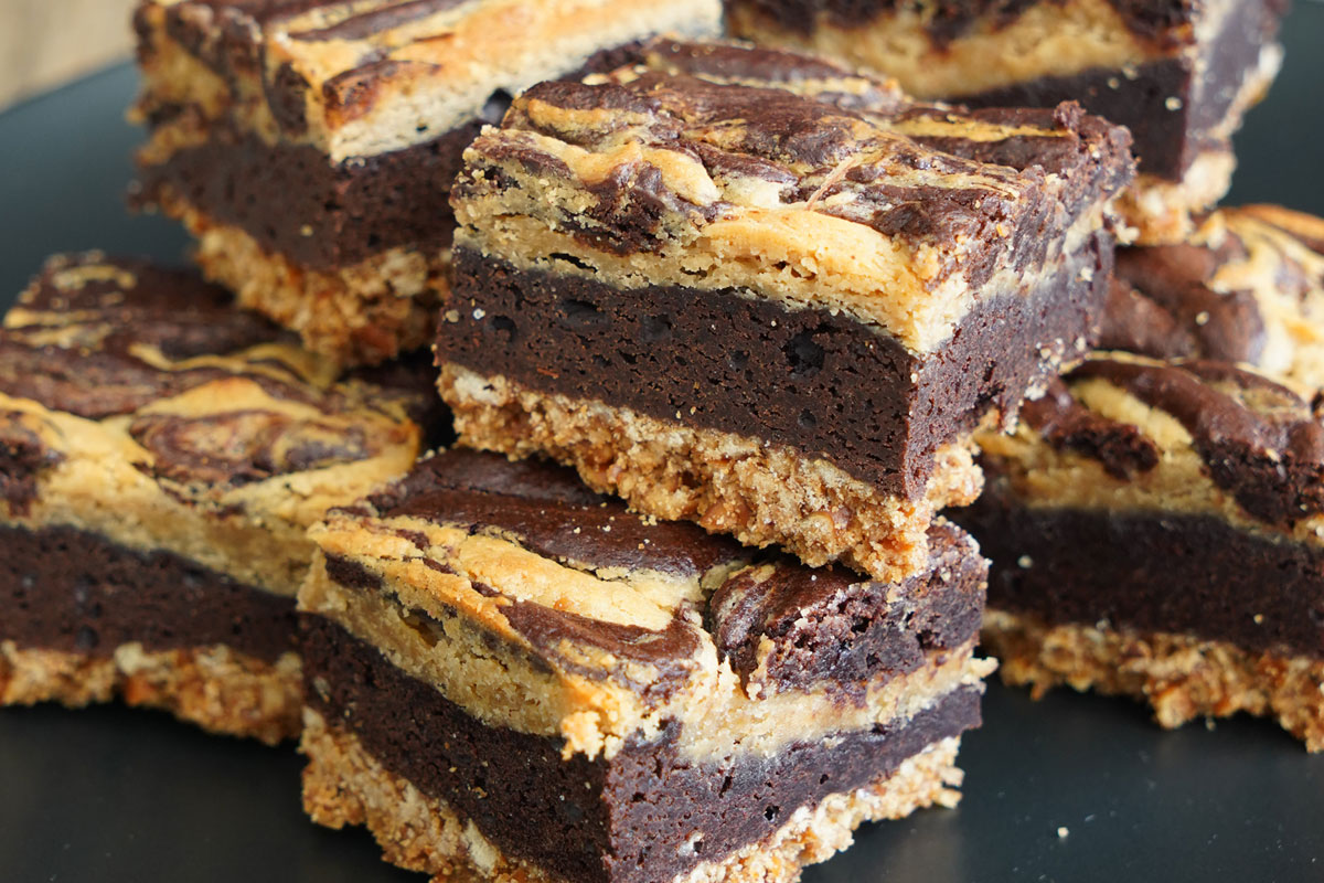 Peanut butter cheesecake brownies in a black plate.